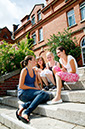 %_tempFileNameteignmouth-campus-four-girls-sitting-on-stairs-1%