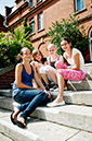 %_tempFileNameteignmouth-campus-four-girls-sitting-on-stairs-2%