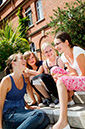 %_tempFileNameteignmouth-campus-four-girls-sitting-on-stairs-4%
